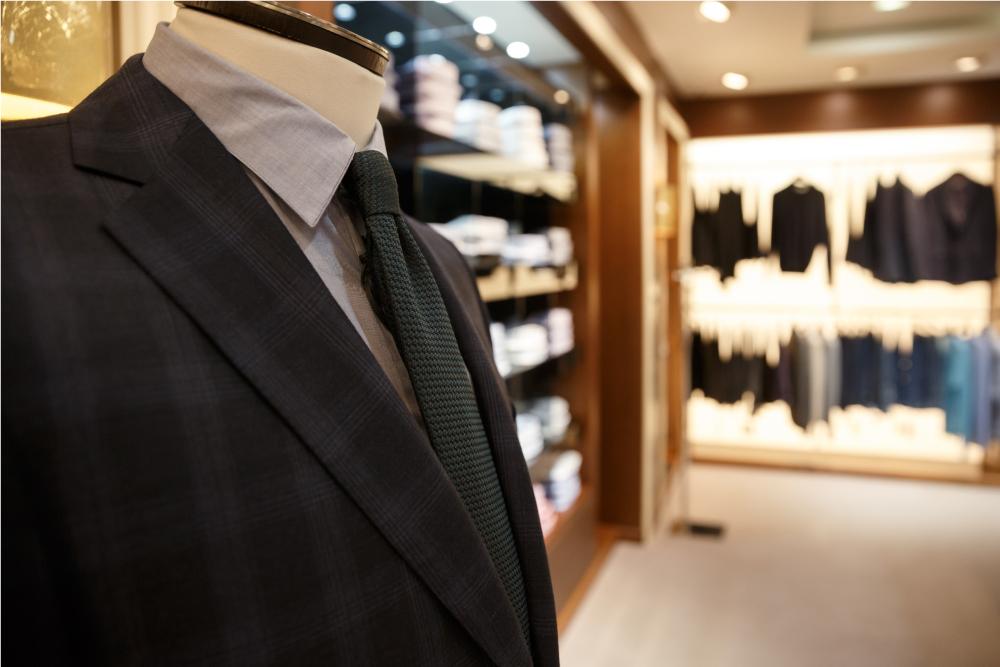 close-up-shot-of-man-suit-jacket-on-hanger-P559HWL