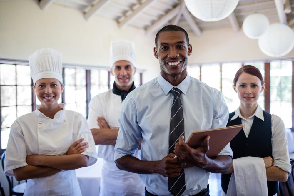 group-of-happy-hotel-staffs-standing-in-hotel-VTH4RKU